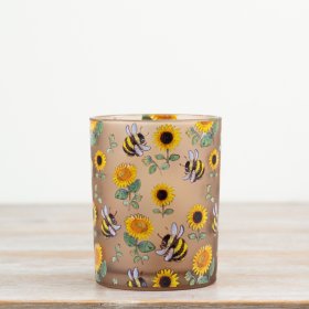 Adorable candle holder featuring a delightful bee motif.