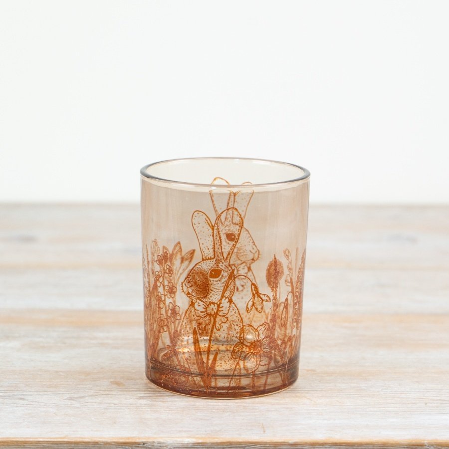 Tall candle holder featuring a rabbit and floral design.