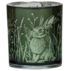 Add a touch of whimsy to your space with this charming green glass candle holder, featuring delicate rabbits and flowers