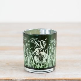 Bring charm to your decor with this green glass candle holder adorned with delicate rabbits and flowers.