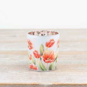 White candle holder featuring an elegant floral design.