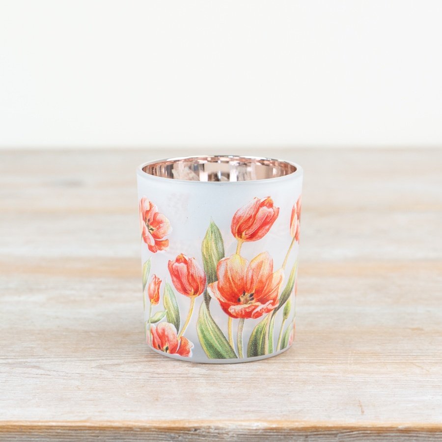White candle holder featuring an elegant floral design.