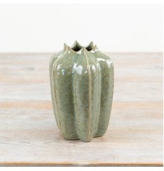 Bring the beauty of nature into the home with this seeded pod inspired vase in a rich green hue.