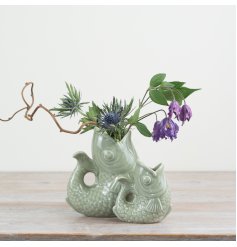 Enhance your decor with this stylish sage green fish vase, perfect for adding a trendy touch to any room.