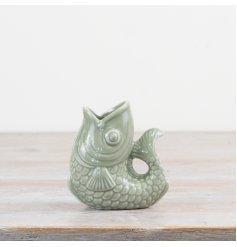 Elevate your space with this on trend fish vase in a sage green colour tone. 