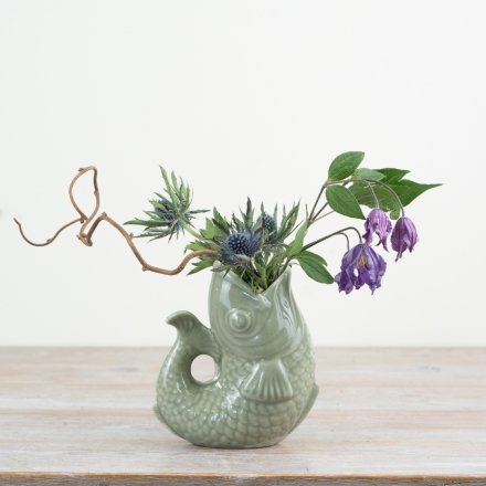 Bring charm to your space with this chic sage green fish-shaped vase.