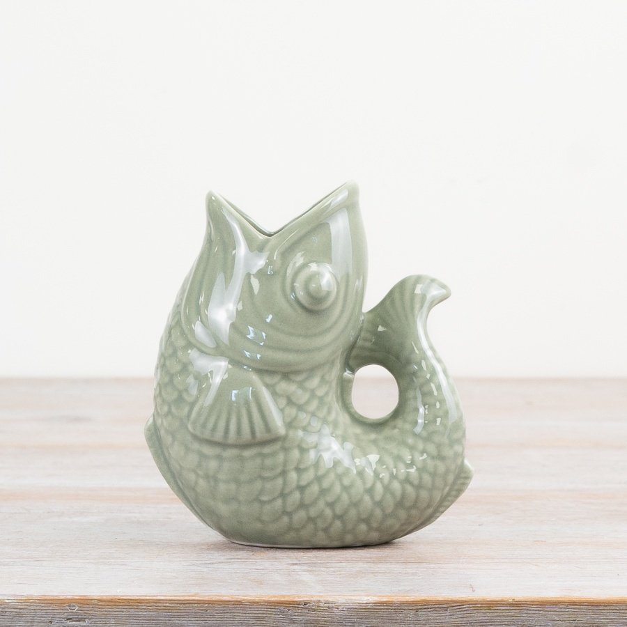 Bring charm to your space with this chic sage green fish-shaped vase.