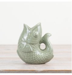 Bring charm to your space with this chic sage green fish-shaped vase.