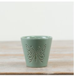 Delicate candle holder in soothing sage green, featuring an elegant butterfly cut-out design.