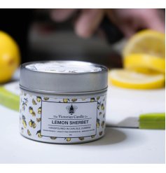 A beautiful metal container scented candle that enhances any space with its aroma.