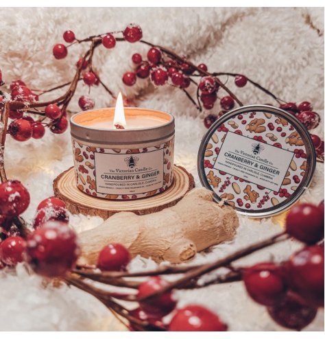 Fruity-scented candle in a metal tin featuring a vibrant animated design.