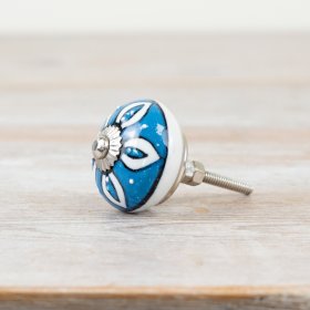 Silver-finished door knob featuring an elegant patterned design.