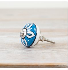 Silver-finished door knob featuring an elegant patterned design.