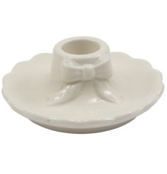 Bring charm and elegance to any room with this 10x4cm cream bow candle holder.