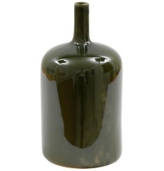 Bring elegance to any space with this stylish green bottle vase.