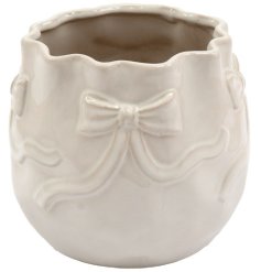Elevate your decor with the stylish and charming B/te Bow Planter.