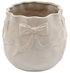 Planter with a stylish bow-shaped design for a chic touch to your greenery.
