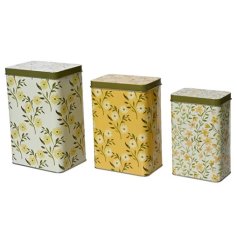 A set of 3 rectangular tins, each printed with a pretty floral design in a pallet of yellow hues. 