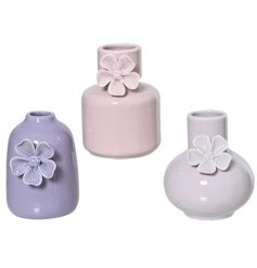 Delicate hand-painted butterfly adorns this elegant porcelain vase