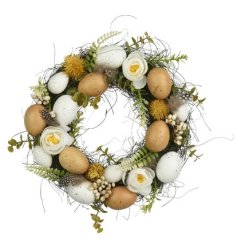 A gorgeous luxury wreath featuring neutral faux eggs and greenery. 