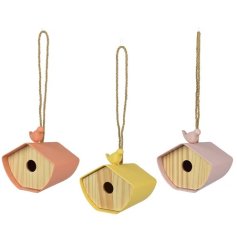 An assortment of 3 colourful bamboo fibre bird houses in pretty yellow, coral and lilac colours. 
