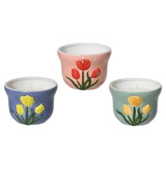 Set of 3 citronella candles with vibrant tulip patterns, perfect for adding color and repelling bugs.