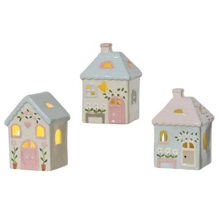A mix of 3 charming cottage style porcelain houses, each with warm glow LED lights. 