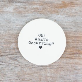 A stylish and humorous porcelain coaster with an embossed design.