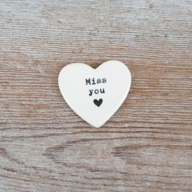 Porcelain heart token with a delicate embossed quote and a small heart detail.