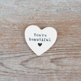 A charming pocket sized keepsake token with an embossed 'you're beautiful slogan'.
