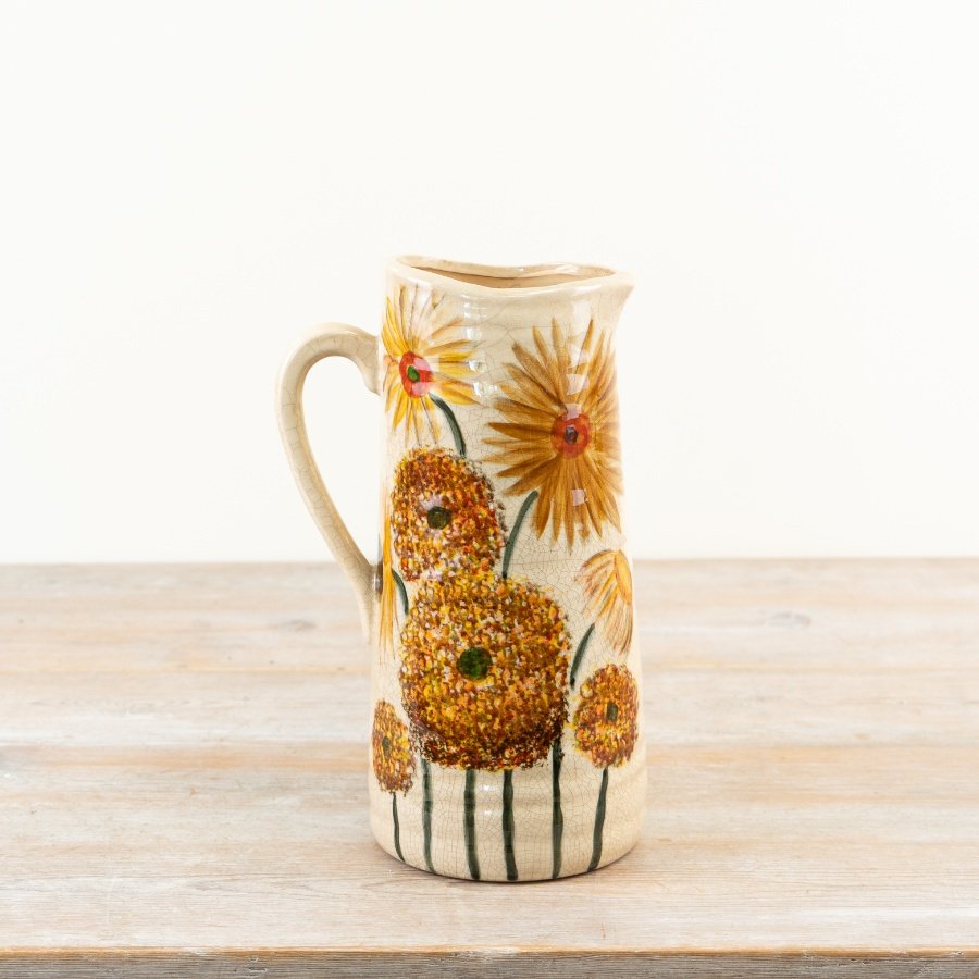 This charming rustic jug showcases vibrant burnt orange and warm buttercup yellow hues.