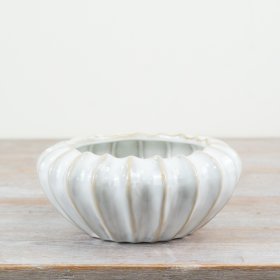 A chic sculptural vessel with a charming, rustic finish. Ideal for planting and displaying as a decorative accessory.