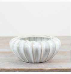 A timeless sculptural vessel with a rich white glaze. Perfect for planting and displaying as a decorative accessory. 