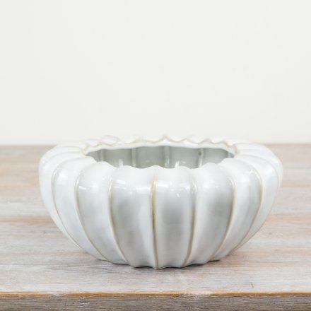 A stylish glazed planter with raw edge details. A must have sculptural vessel for the home. 