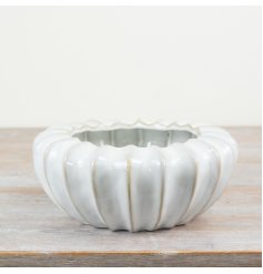 A stylish glazed planter with raw edge details. A must have sculptural vessel for the home. 