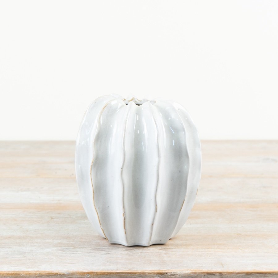 Meet this botanical pod vase, elegantly coated in a smooth off-white glaze.
