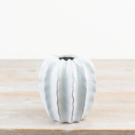 A chic on trend pod vase finished with an off white glaze. 