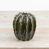 A gorgeous green vase in the shape of a pod, complete with a glazed finish.
