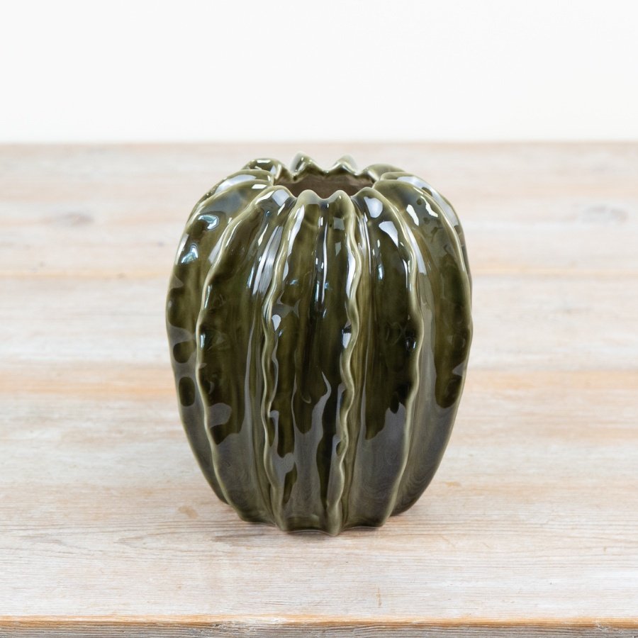 Beautiful green pod-shaped vase with a glossy, glazed finish.