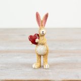 A charming rabbit holding a gorgeous red heart. 