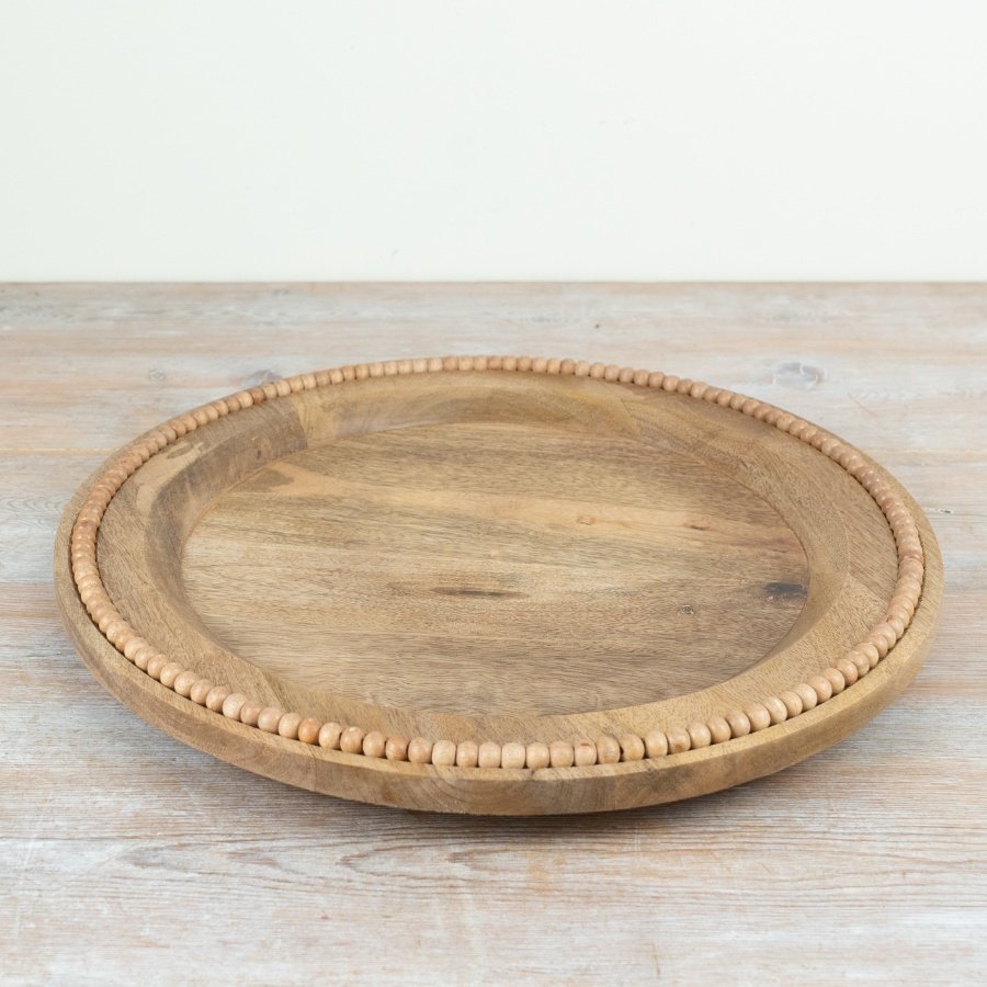 Delightful wooden plate featuring elegant bead trim design.
