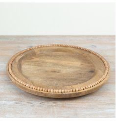 a charming wooden plate with bead edging 