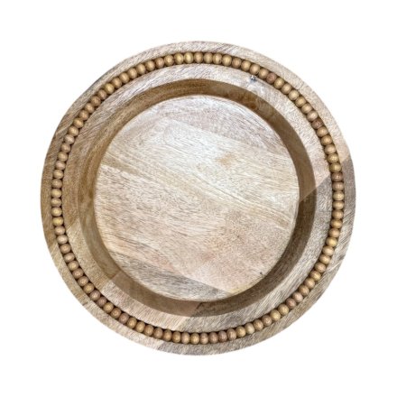 A chic wooden round plate with beading around the rim.
