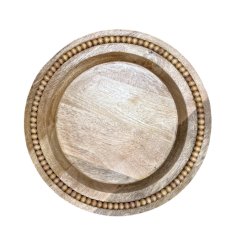 A chic wooden round plate with beading around the rim.