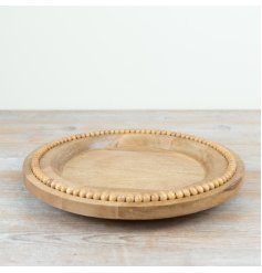 A chic wooden round plate with beading around the rim.