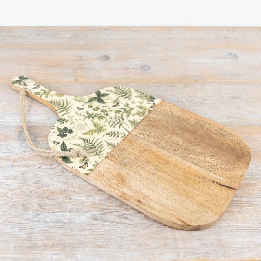 A rustic wooden board decorated with an enamel fern print handle. A stunning and practical home decoration. 