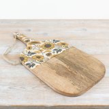 A rustic wooden board with a colourful enamel panel featuring bold and beautiful sunflowers. 