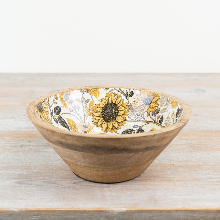 A rustic enamel and mango wood bowl featuring a warm and rustic sunflower print. 