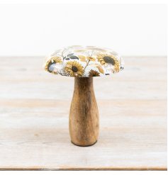 A rustic wooden mushroom ornament with a bold and beautiful enamel sunflower cap. 