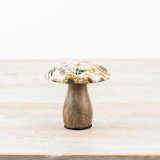 A rustic wooden mushroom with a colourful enamel cap featuring a warm yellow sunflower pattern. 